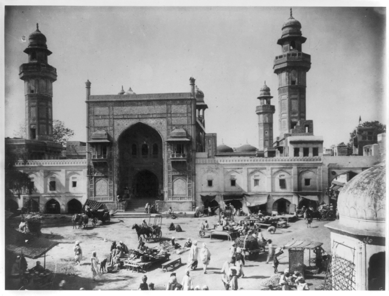 Historic photograph of the gateway and surrounding street of the mosque catalogued as the Great Mosque of Vazir Khan in Lahore.